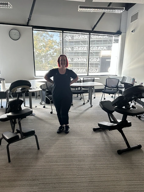 Friendly corporate massage therapists promoting workplace wellness and relaxation.